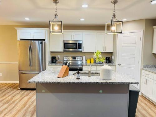 a kitchen with a refrigerator and a counter top at Spacious home, 3 king beds, huge backyard near UM in Memphis