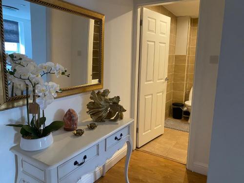 a bathroom with a white dresser with a mirror at Aston Apartment 4 -Secure Parking in Birmingham