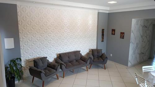 een wachtkamer met twee stoelen en een muur bij Apartamento a 1200m da praia 2 quartos in Vila Velha