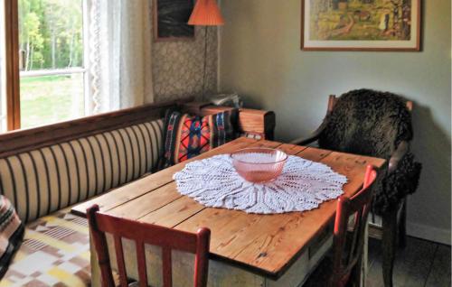 a wooden table with a bowl on top of it at Holiday Home Fagelfors With Fireplace I in Fåglebo
