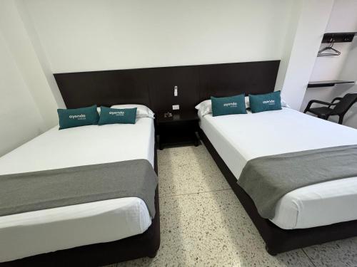 Una cama o camas en una habitación de Hotel Mar Inn Cali