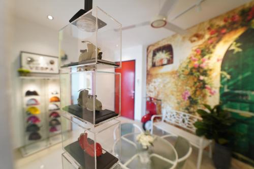 a room with a display case with shoes in it at 家 Majestic Ipoh in Ipoh
