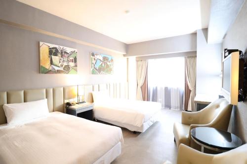 Postel nebo postele na pokoji v ubytování Kaohsiung Ahotel