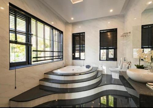 a bathroom with two sinks and a bath tub at Orestay Garden Hạ Long in Ha Long