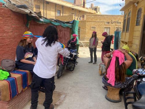 a group of people standing around in a street at Blue Eye Hostel in Jaisalmer