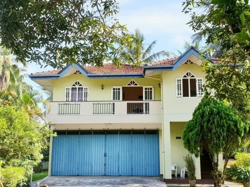 a house with a blue garage at Mohotti House in Galle