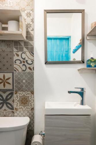 a bathroom with a sink and a mirror at Casa Toloc Tulum in Tulum