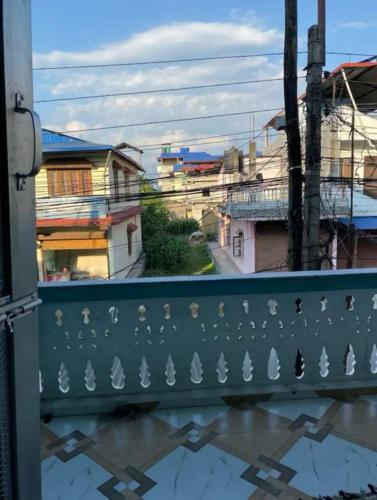 a green fence with white birds on it at pujan's homestay in Bharatpur