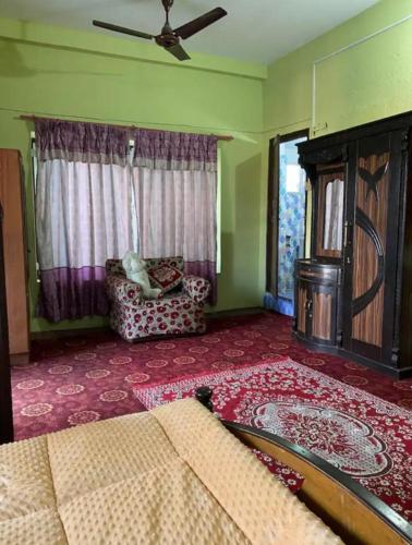 a living room with a couch and a window at pujan's homestay in Bharatpur
