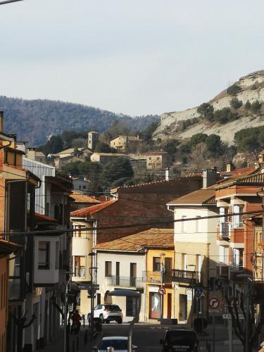 a city street with buildings and cars on a hill at Ca la conxita in Tona