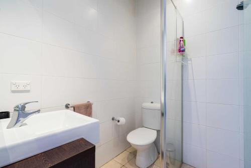 a bathroom with a toilet and a sink and a shower at Cosy Cottage Funky ICC Darling Harbour Sydney in Sydney