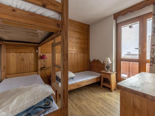 a bedroom with two bunk beds and a window at Appartement Plagne 1800, 2 pièces, 7 personnes - FR-1-351-70 in Plagne 1800