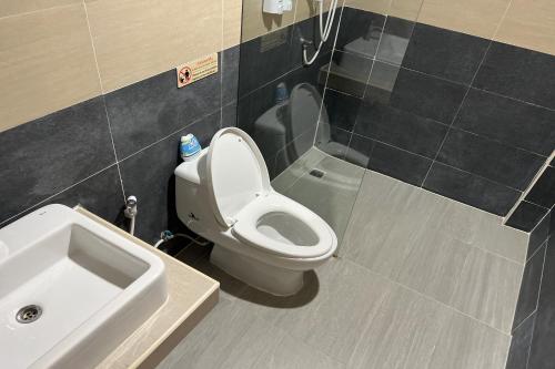 a bathroom with a toilet and a sink at V Tharm Hotel in Udon Thani