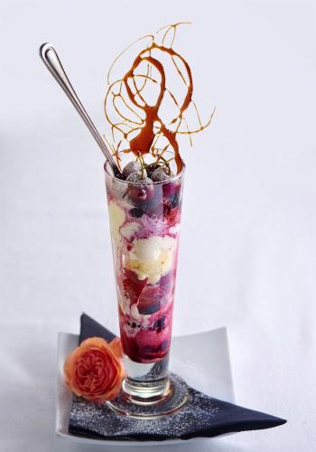 a drink with whipped cream and fruit in a glass at Escape To Picton Boutique Hotel in Picton