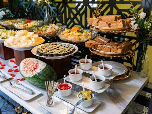 a buffet with many different types of food on a table at Hanoi EcoStay 1 hostel in Hanoi