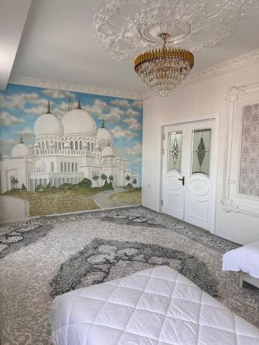 a bedroom with a painting of a building on the wall at Квартира Самарканд in Samarkand