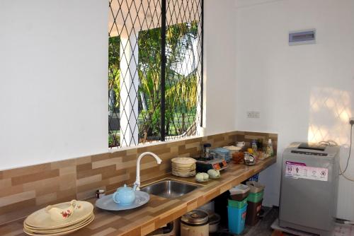 a kitchen counter with a sink and a window at Villa Weligama Gedara in Weligama
