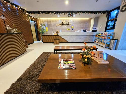 a store lobby with a table with flowers on it at Jaelle Residences Hotel - Downtown in Lucena