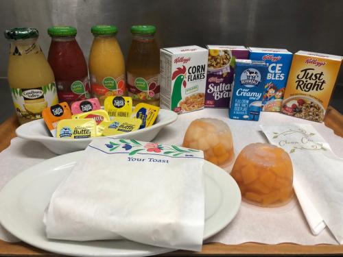 a table topped with plates of food and other foods at Comfort Inn on Main Hervey Bay in Hervey Bay