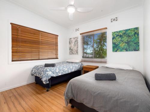 a bedroom with two beds and a window at Beach House on Pearl - Kingscliff Central in Kingscliff