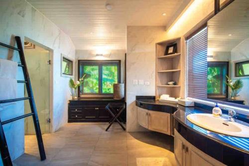 a bathroom with a sink and a large mirror at Lang- Villa Amara，Kamala beach luxury villa in Surin Beach