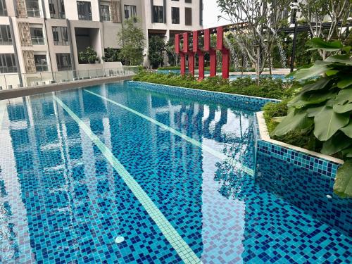 a blue swimming pool with a red chair in a building at SS KL Sentral by NomadNest in Kuala Lumpur