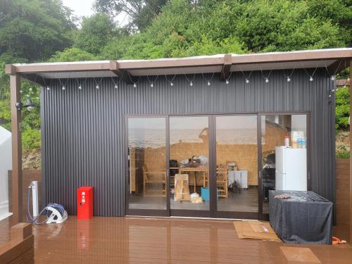 a gray shed with a view of a kitchen at -SORA-BASE（ソラベース） in Toyohama
