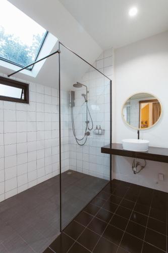 a bathroom with a shower and a sink at Karpenter Lampang in Lampang