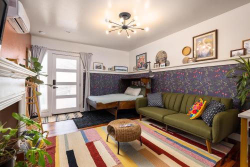 a living room with a green couch and a fireplace at The Salish Suite in Mount Vernon