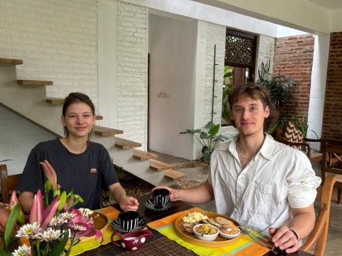 a man and woman sitting at a table with a plate of food at Rai Villa Colombo in Colombo