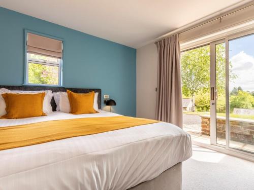 a bedroom with a large bed and a large window at 3 Bed in St. Mellion 87718 in St Mellion