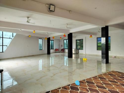 a large room with a dance floor with balls on the floor at Hotel Dawat in Pura Raghunāth