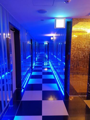a hallway with blue lights in a building at Star Motel in Daegu