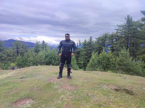 a man standing on top of a grassy hill at shake villa in Yeraoda