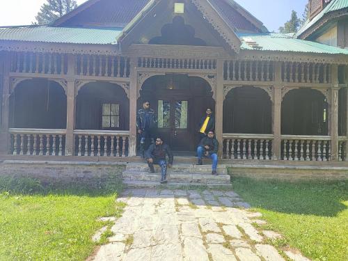 a group of people sitting on the steps of a building at shake villa in Yeraoda