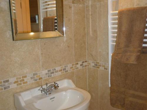 a bathroom with a sink and a mirror at 1 bed in Kilmory CA344 in Kilmory