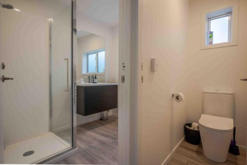 a bathroom with a shower and a sink at Cliffside - Akaroa Holiday Home in Akaroa