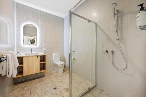 a bathroom with a shower and a toilet and a sink at Comfort Inn Regal Park in Adelaide