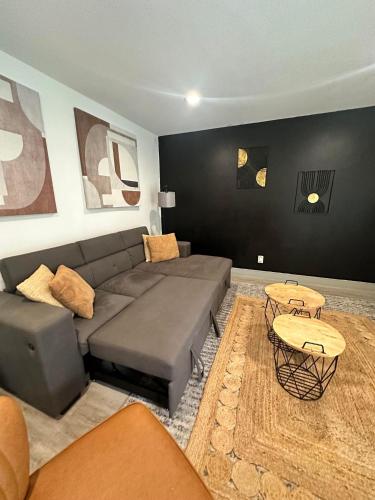 a living room with a couch and a table at Trendy Midtown Apartment in Houston