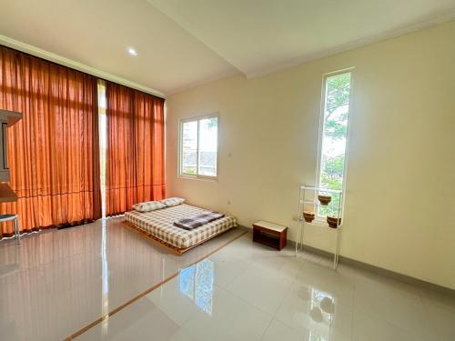 a bedroom with a bed and a large window at Pesona Sinduadi Homestay Jogja in Jetis