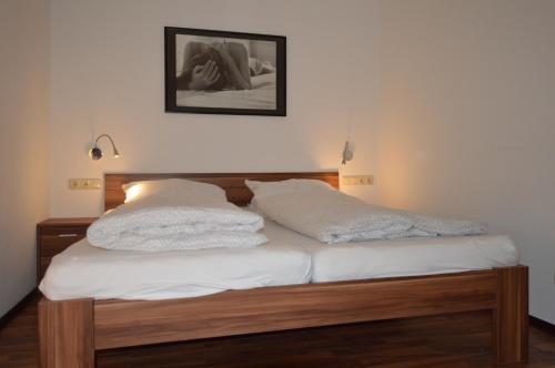 a bed with two white pillows on top of it at Schlafen in Stade in Stade