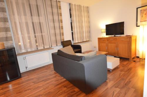 a living room with a couch and a tv at Schlafen in Stade in Stade