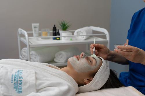 a woman lying in a hospital bed getting a injection at Casa di Fiore SPA and Medical Hotel, Mineral Pools & Private Beach in Kranevo