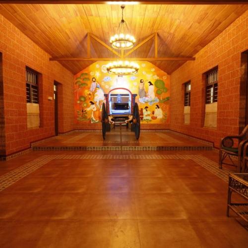 a car parked in a room with a painting on the wall at Cure Monastery Family Resort in Marayoor