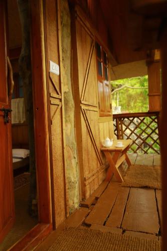 an entrance to a room with a door and a table at Cure Monastery Family Resort in Marayoor