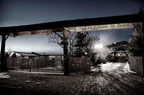 a gate with a sign in front of a fence at Karczma Taberska in Kolesin