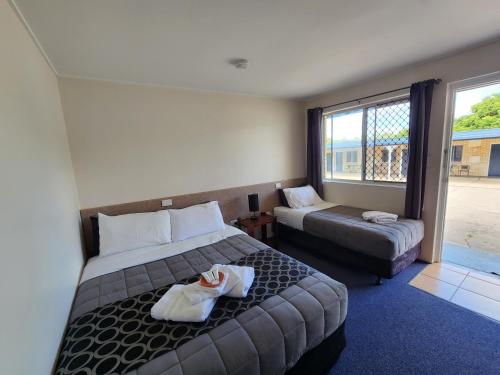 a hotel room with two beds and a window at Nanango Star Motel in Nanango