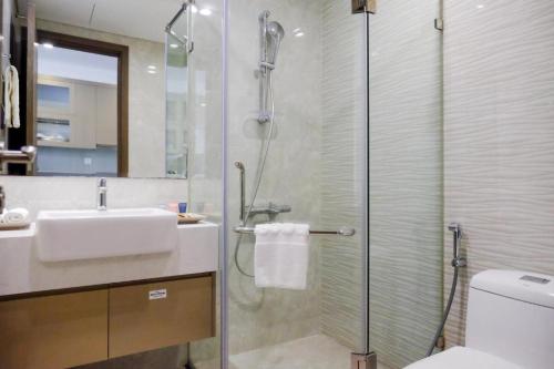 a bathroom with a shower and a sink and a toilet at Vinhomes Westpoint HN - by BAY LUXURY in Hanoi