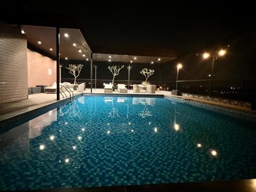 a large swimming pool at night with lights on it at Paragon House and Residence in Hanoi