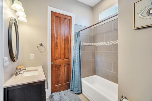a bathroom with a tub and a sink and a shower at Spacious Centrally Located Home in New Orleans